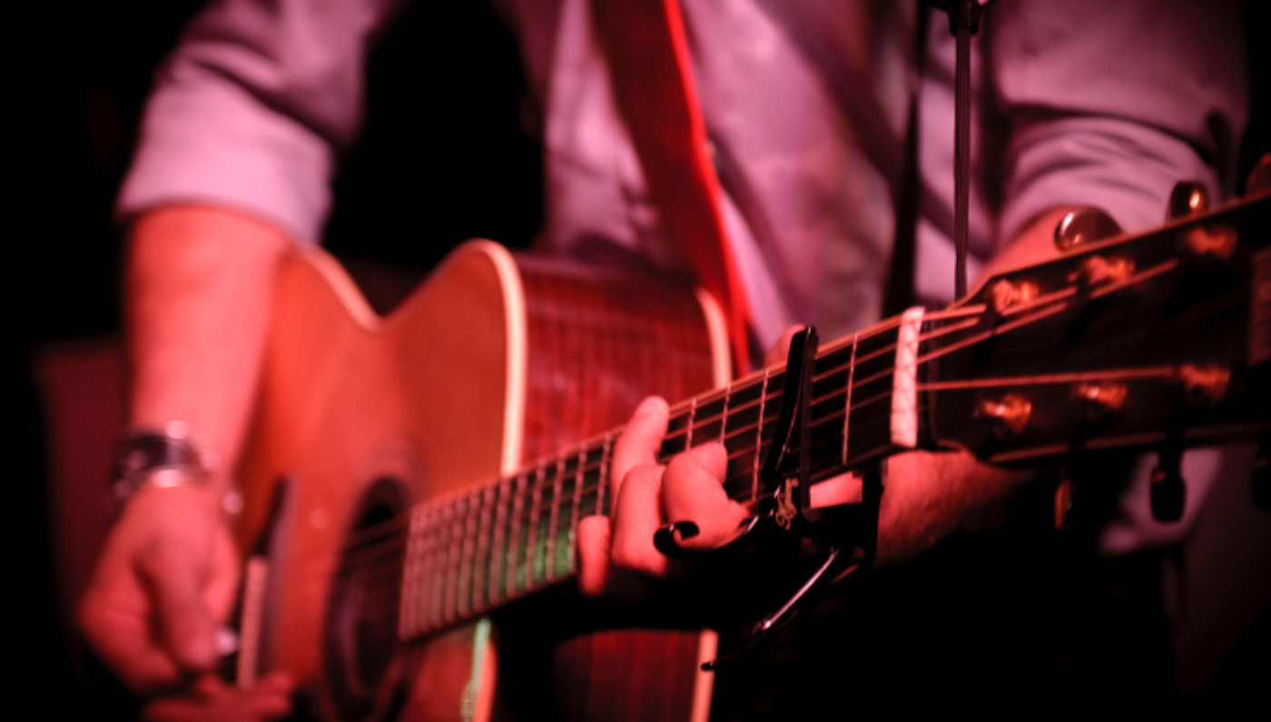Gros plan sur une personne jouant de la guitare accoustique